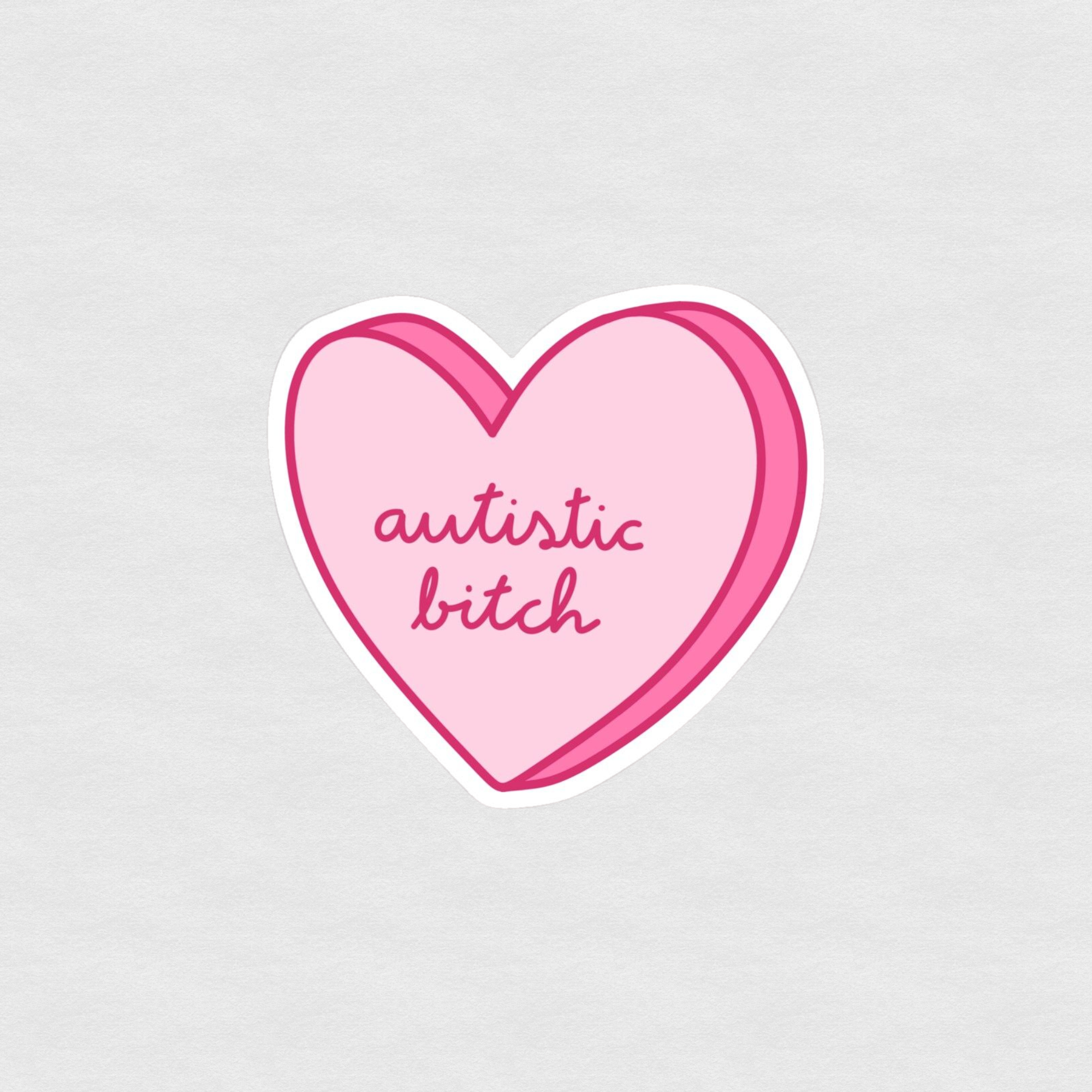 Pink heart sticker with handwritten text reading “autistic bitch”