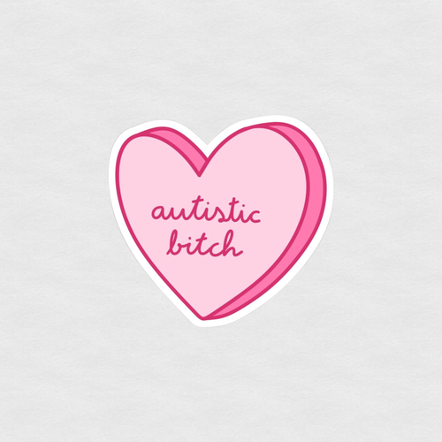 Pink heart sticker with handwritten text reading “autistic bitch”