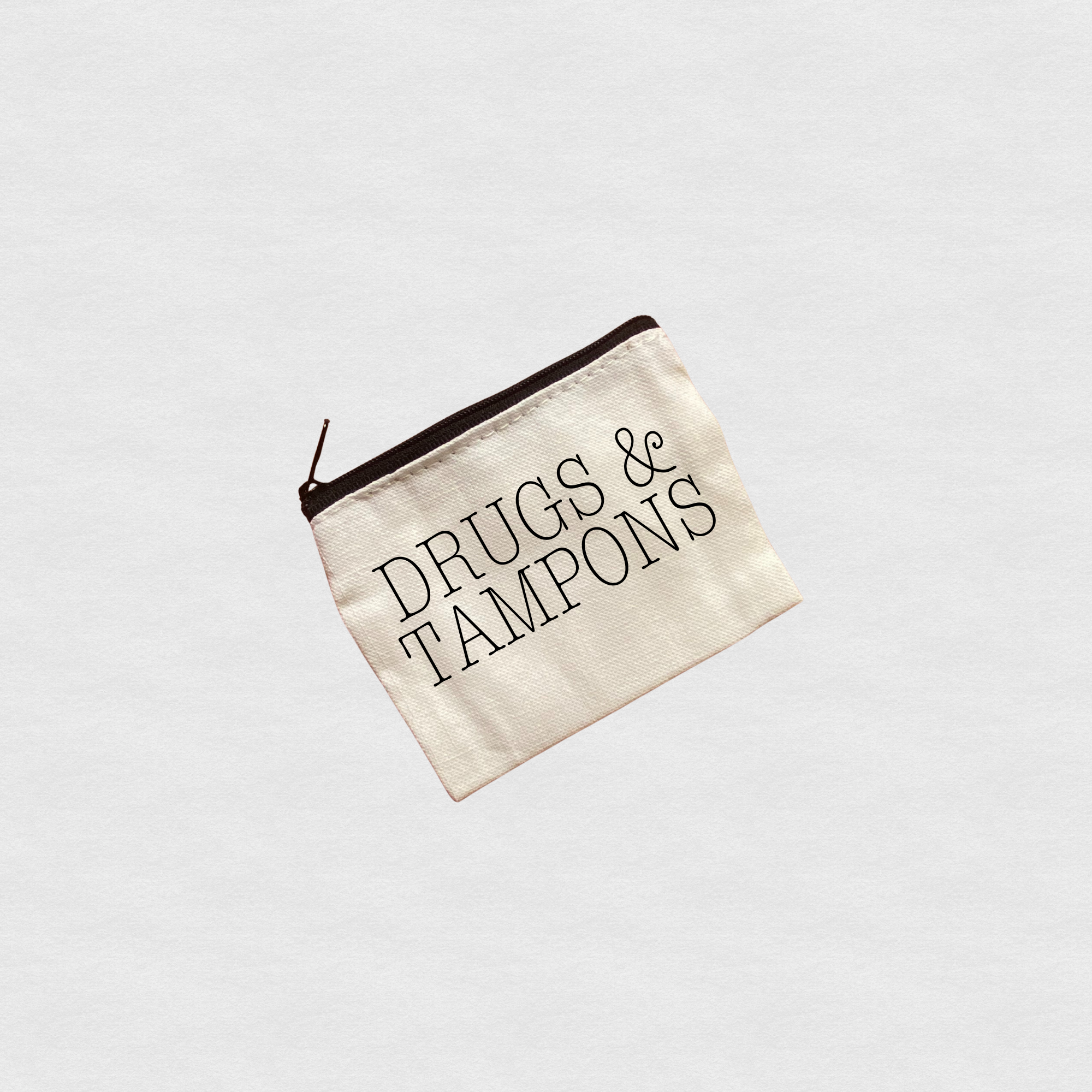 Canvas zipper pouch with “Drugs & Tampons” minimalist text design