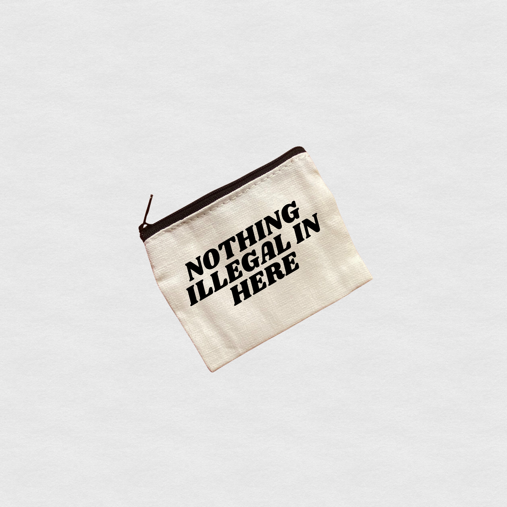 Canvas zipper pouch with “Nothing Illegal In Here” bold text design