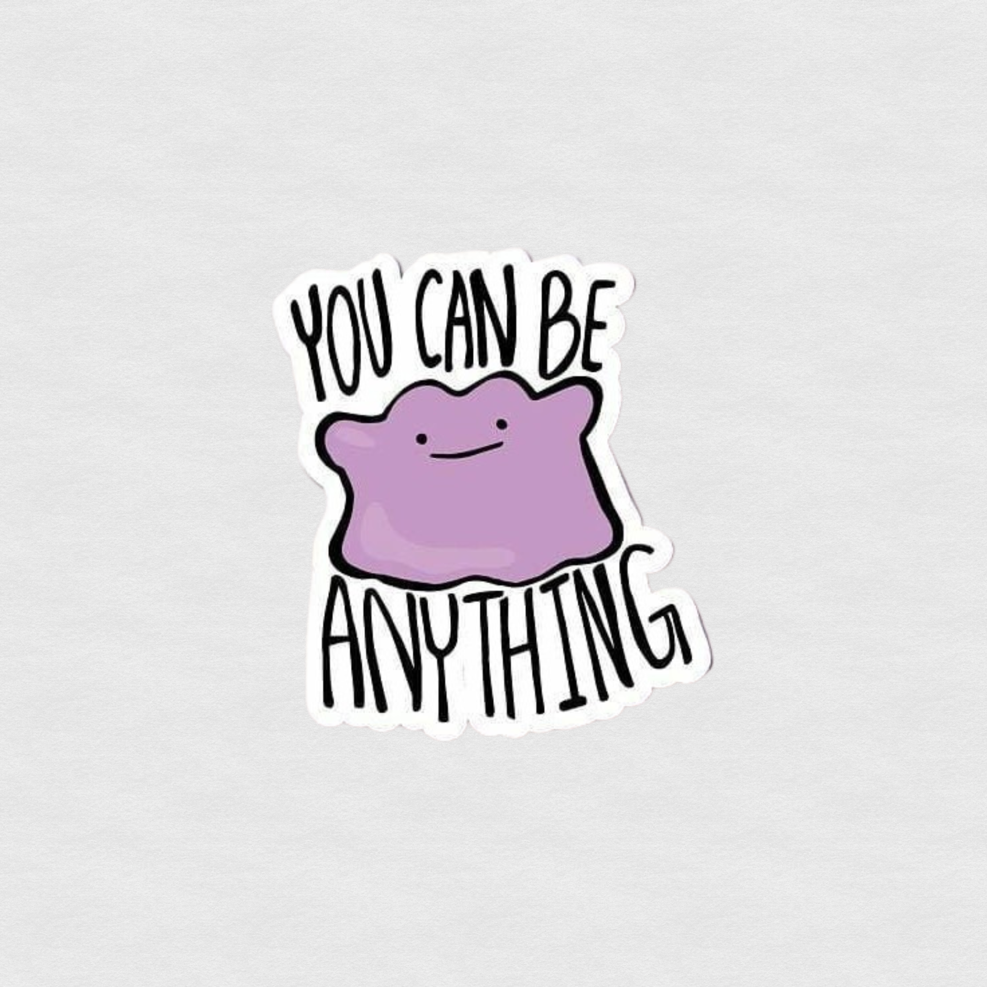 Cute purple blob character sticker with text “You can be anything” in playful black lettering